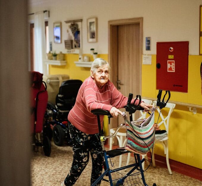 Old Woman with Walking Frame in Nursing Home